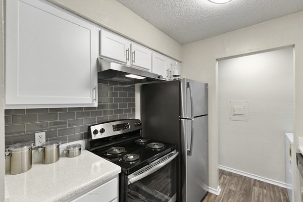Modern kitchen featuring stainless steel appliances at Creekwood Apartments