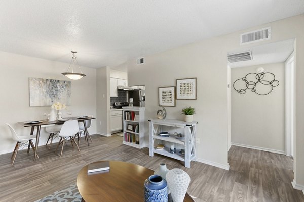 Inviting living room with plush seating and natural light at Creekwood Apartments
