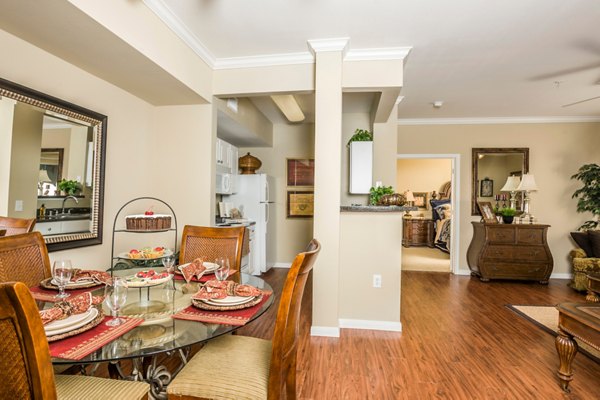 Dining room featuring elegant chandelier and modern decor in Broadwater Apartments