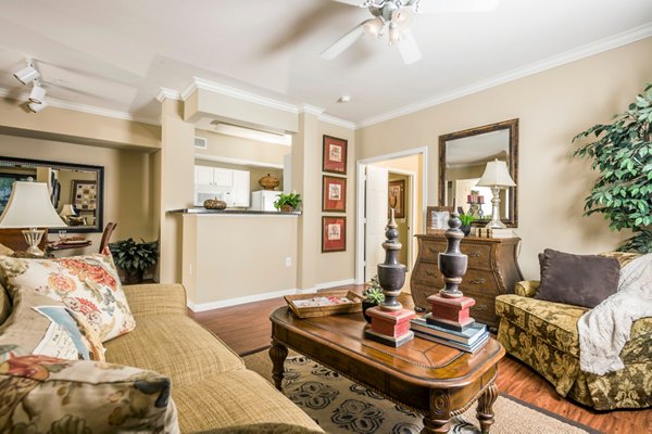 Spacious living room featuring modern decor and large windows at Broadwater Apartments