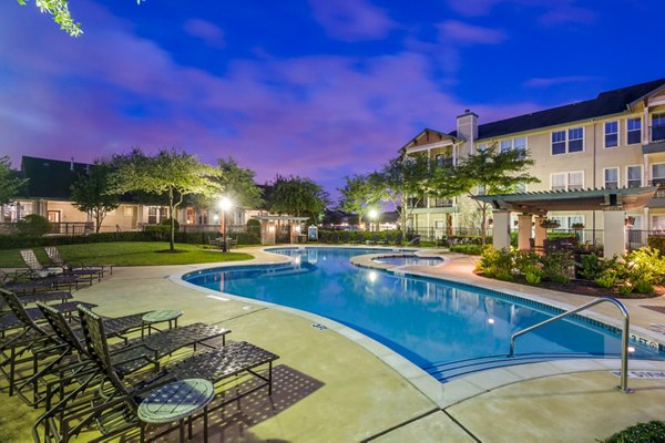 Serene outdoor pool at Broadwater Apartments with lounge seating and greenery