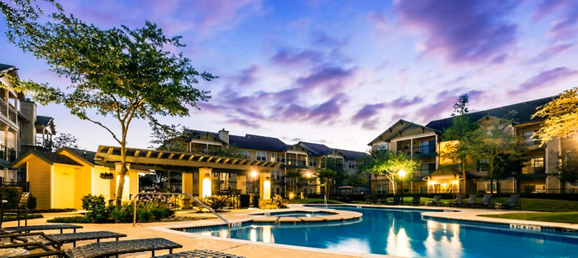 Luxury pool with lounge chairs at Broadwater Apartments, a Greystar property