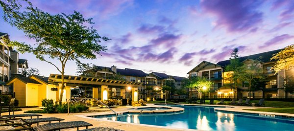 Luxury pool with lounge chairs at Broadwater Apartments, a Greystar property