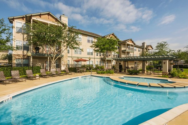 Rooftop pool with poolside seating at Broadwater Apartments