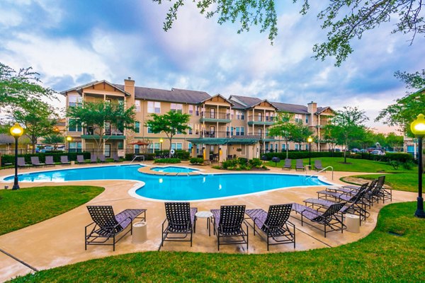 Luxurious pool area at Broadwater Apartments with lounge seating and shaded cabanas
