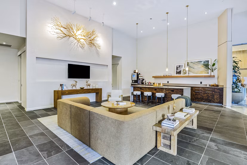 Modern clubhouse with sleek lobby design at 44 Monroe Apartments, featuring luxurious seating areas and ambient lighting