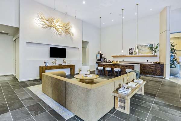 Modern clubhouse with sleek lobby design at 44 Monroe Apartments, featuring luxurious seating areas and ambient lighting