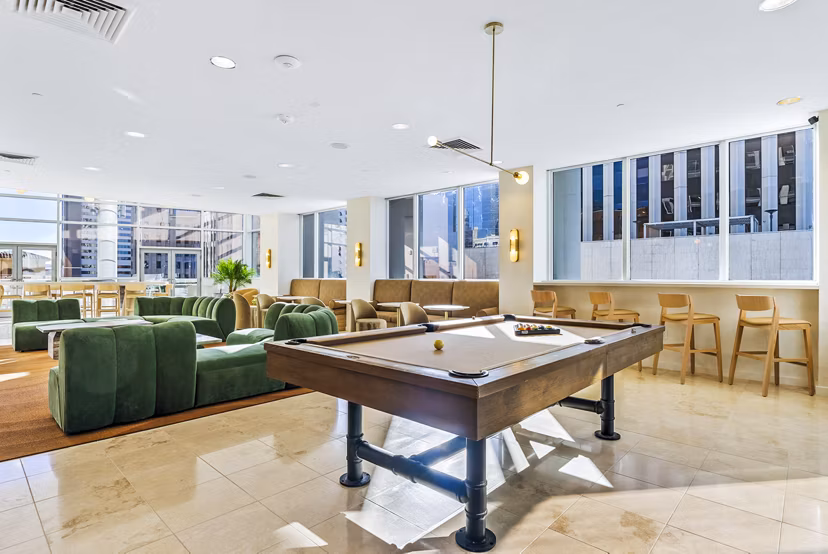 Clubhouse game room featuring pool table and seating at 44 Monroe Apartments