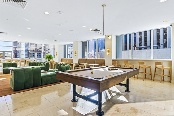 Clubhouse game room featuring pool table and seating at 44 Monroe Apartments