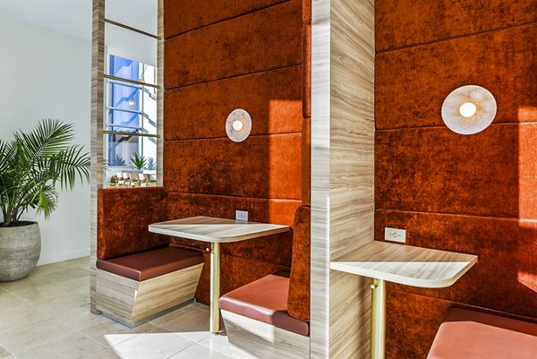 Clubhouse featuring modern decor and seating areas at 44 Monroe Apartments