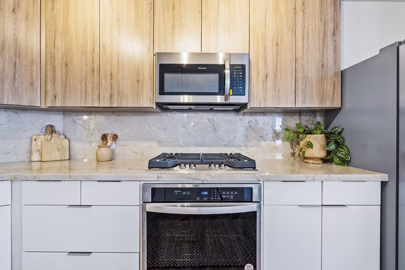 Modern kitchen with granite countertops and stainless steel appliances at 44 Monroe Apartments