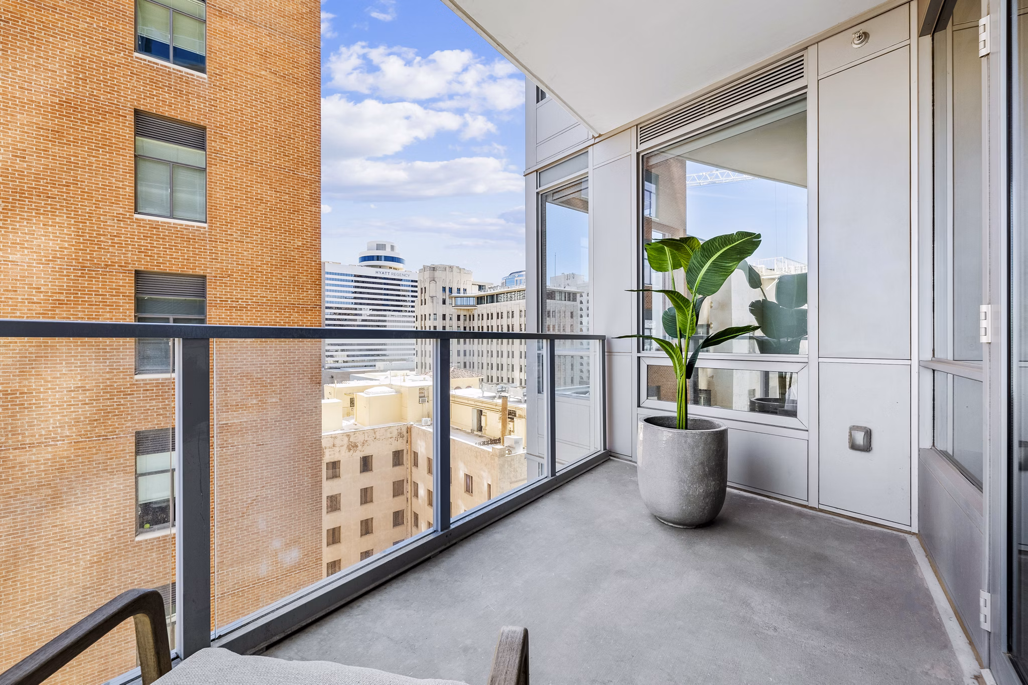 Patio with modern furniture and views at 44 Monroe Apartments