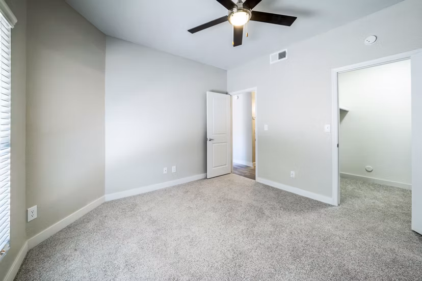 Cozy bedroom with modern decor at Hayden Park Apartments, featuring plush bedding and natural light, offering luxury living in Greystar's community