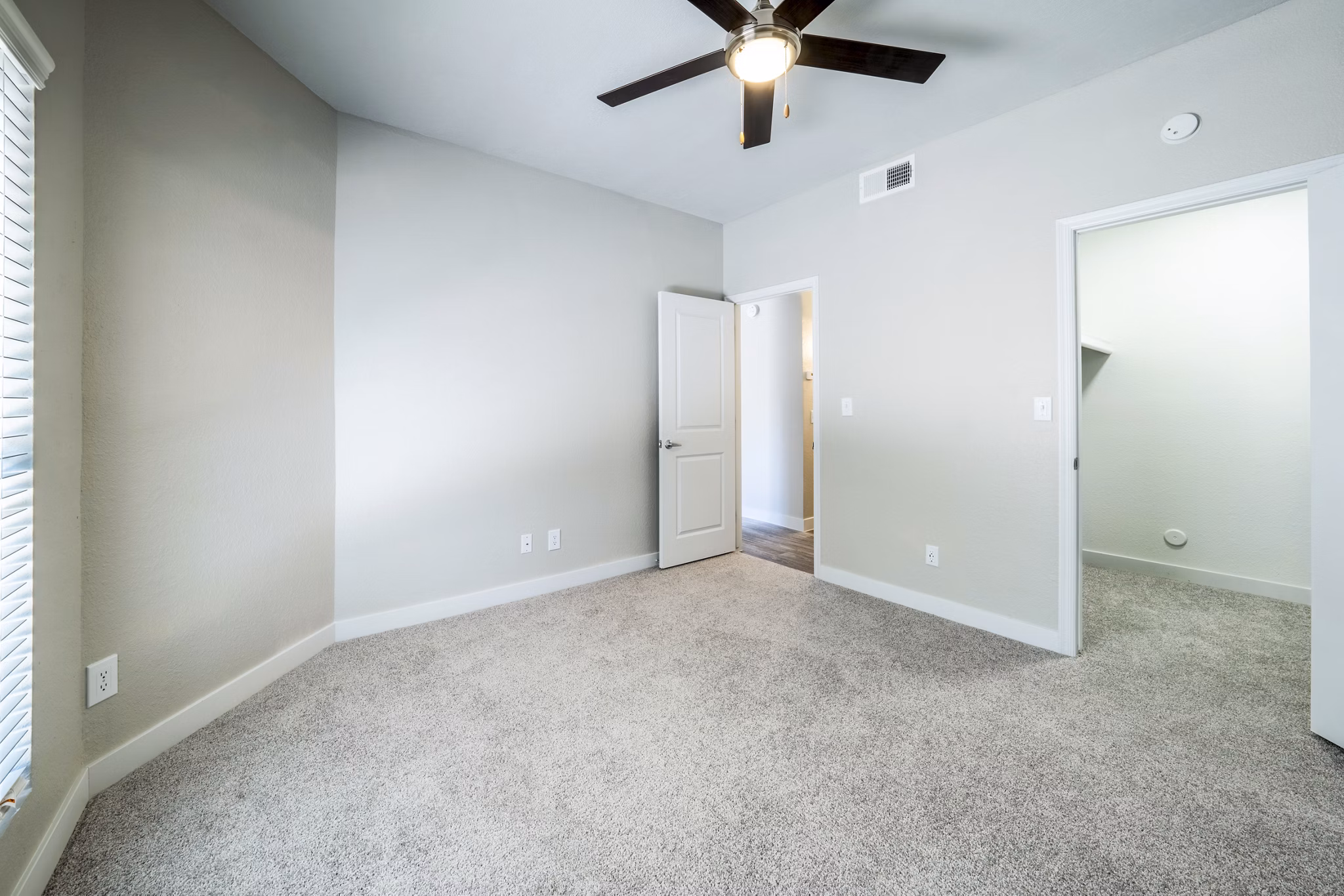 Cozy bedroom with modern decor at Hayden Park Apartments, featuring plush bedding and natural light, offering luxury living in Greystar's community