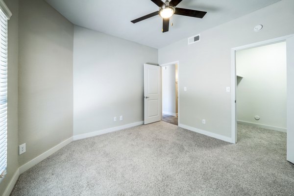 Cozy bedroom with modern decor at Hayden Park Apartments, featuring plush bedding and natural light, offering luxury living in Greystar's community