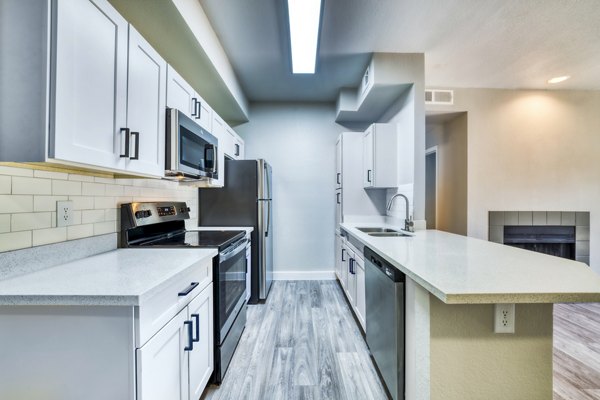 Modern kitchen with stainless steel appliances at Hayden Park Apartments