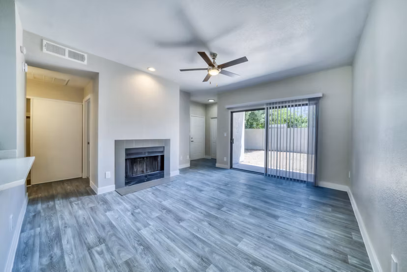 Spacious living room with sleek furniture and large windows in Hayden Park Apartments