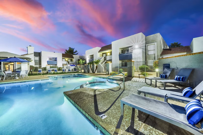 Relaxing outdoor pool with lounge chairs at Hayden Park Apartments, offering a luxury lifestyle experience in a serene setting