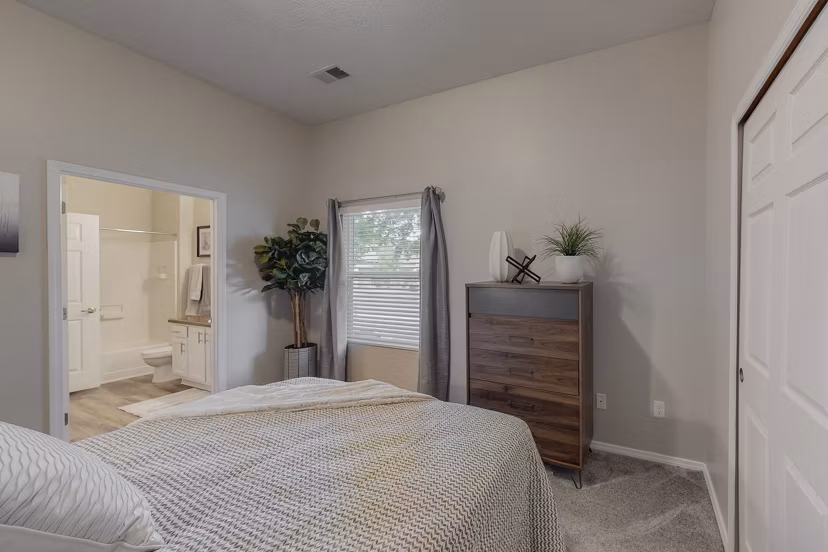 Cozy bedroom with stylish decor at Cantata at the Trails Apartments, showcasing luxury living in a welcoming environment