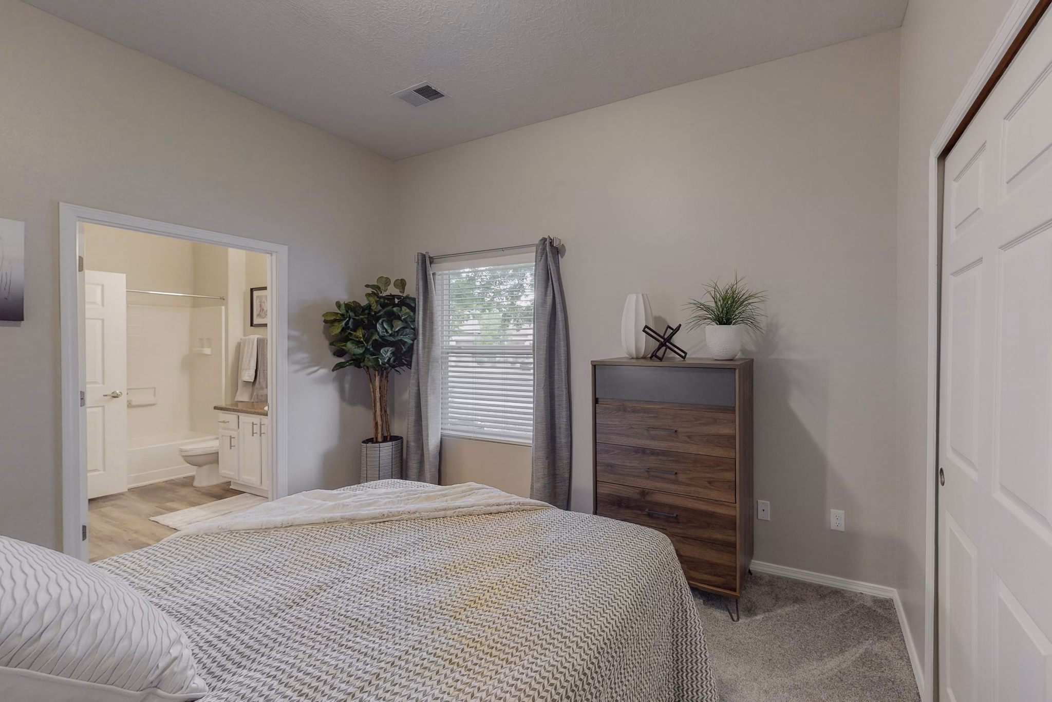 Cozy bedroom with stylish decor at Cantata at the Trails Apartments, showcasing luxury living in a welcoming environment