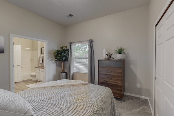Cozy bedroom with stylish decor at Cantata at the Trails Apartments, showcasing luxury living in a welcoming environment