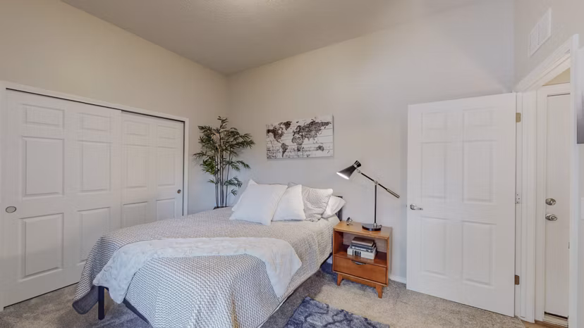 Spacious bedroom with modern decor in Cantata at the Trails Apartments - Greystar luxury living