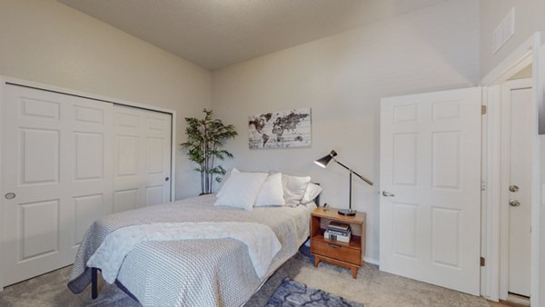 Spacious bedroom with modern decor in Cantata at the Trails Apartments - Greystar luxury living
