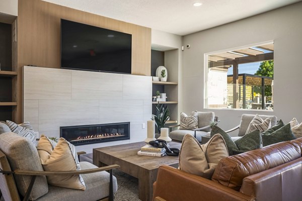 Clubhouse featuring modern design and spacious seating at Cantata at the Trails Apartments