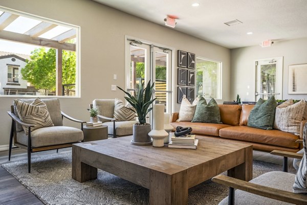 Clubhouse with modern decor and seating at Cantata at the Trails Apartments, luxury living by Greystar