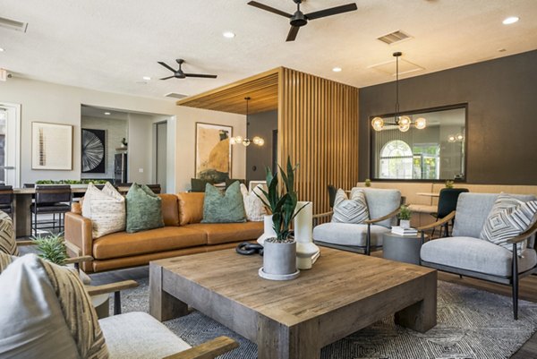 Clubhouse featuring modern design and spacious seating at Cantata at the Trails Apartments