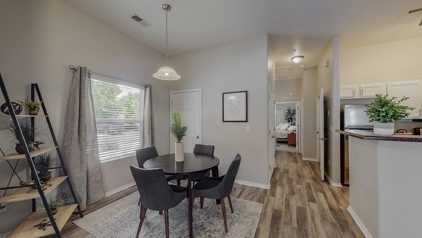 Dining area featuring modern furniture and open layout in Cantata at the Trails Apartments