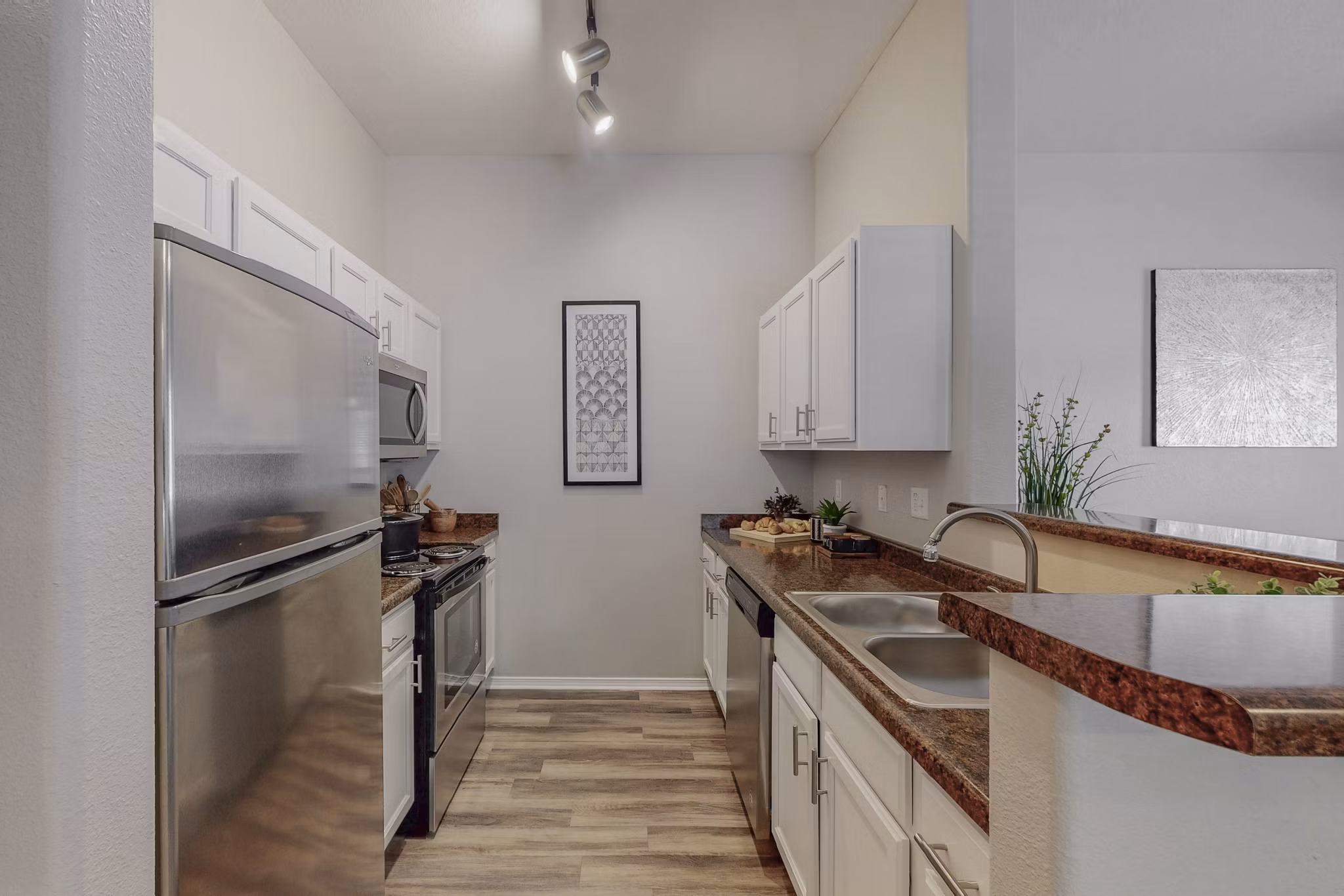 Modern kitchen with stainless steel appliances at Cantata at the Trails Apartments, offering luxury living spaces