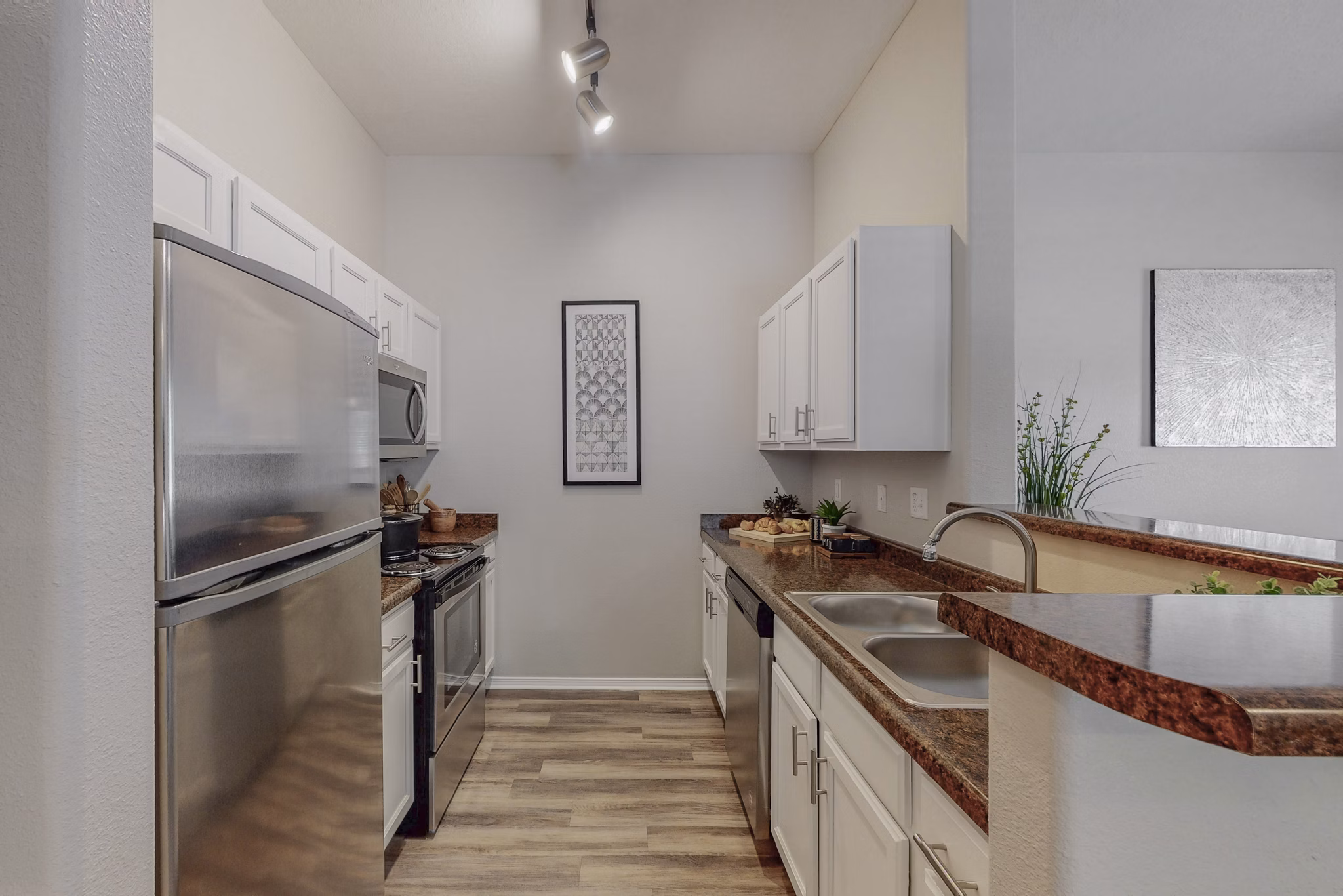 Modern kitchen with stainless steel appliances at Cantata at the Trails Apartments, offering luxury living spaces