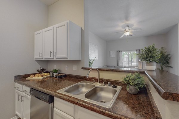 Modern kitchen with stainless steel appliances at Cantata at the Trails Apartments in Albuquerque
