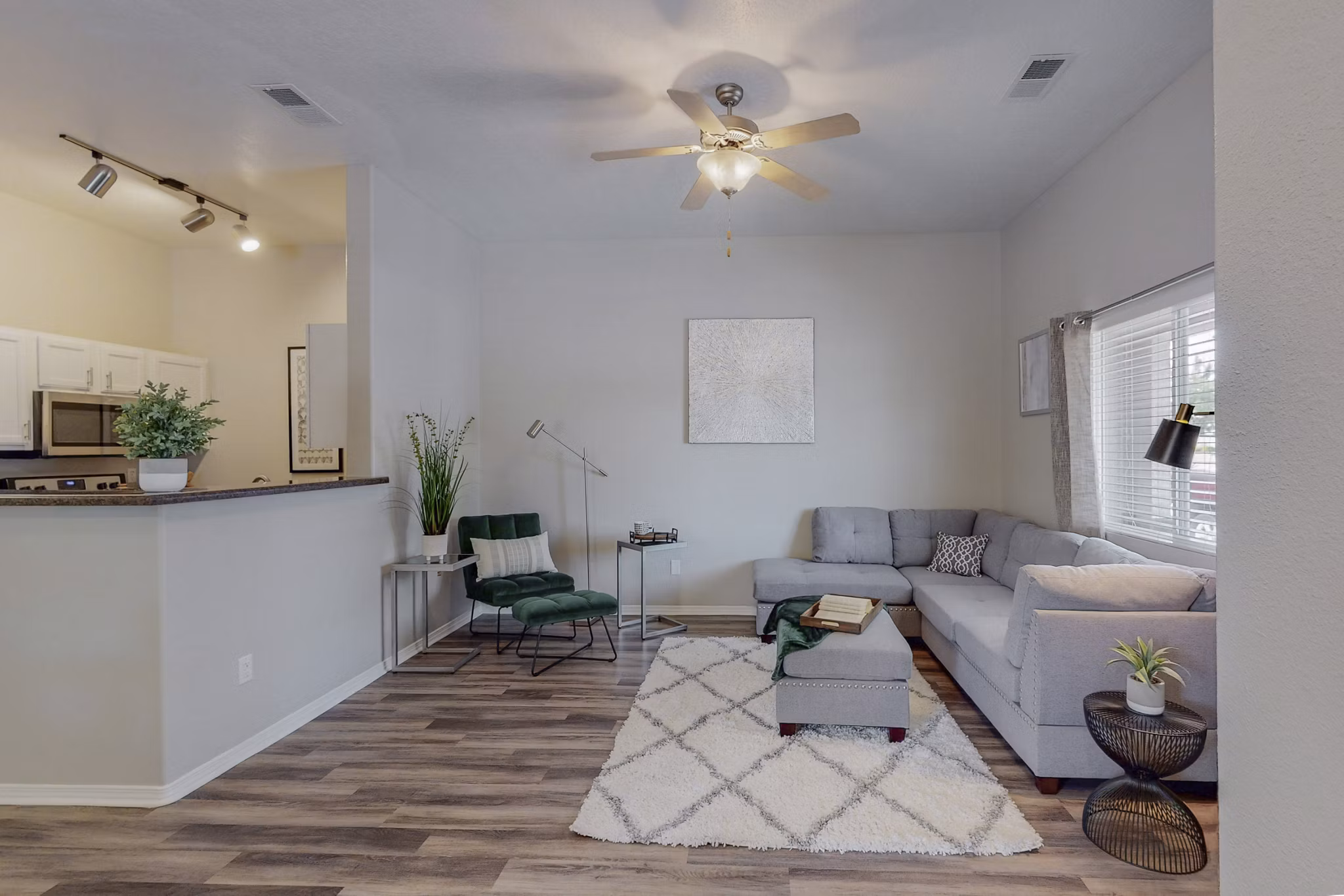Stylish living room with cozy seating and natural light at Cantata at the Trails Apartments, exemplifying luxury living spaces