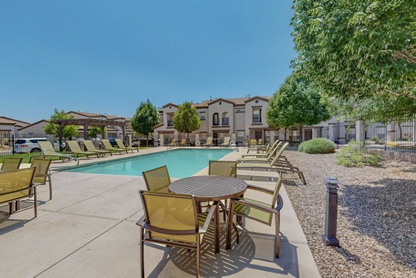 Resort-style pool with lush landscaping at Cantata at the Trails Apartments