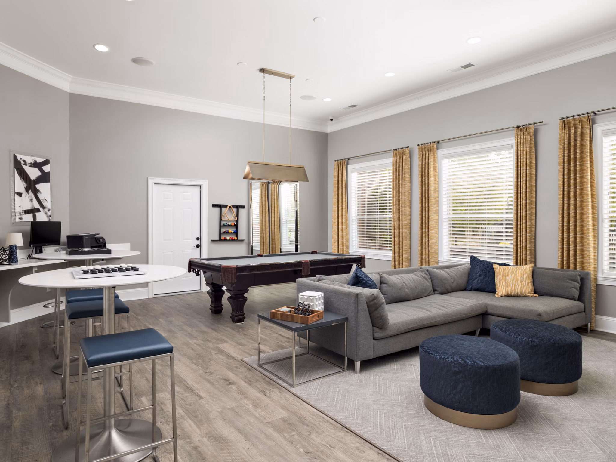 Clubhouse game room at Mandalay Villas Apartments with billiards table and lounge seating, ideal for social gatherings and leisure activities