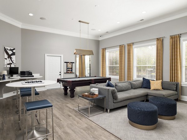 Clubhouse game room at Mandalay Villas Apartments with billiards table and lounge seating, ideal for social gatherings and leisure activities