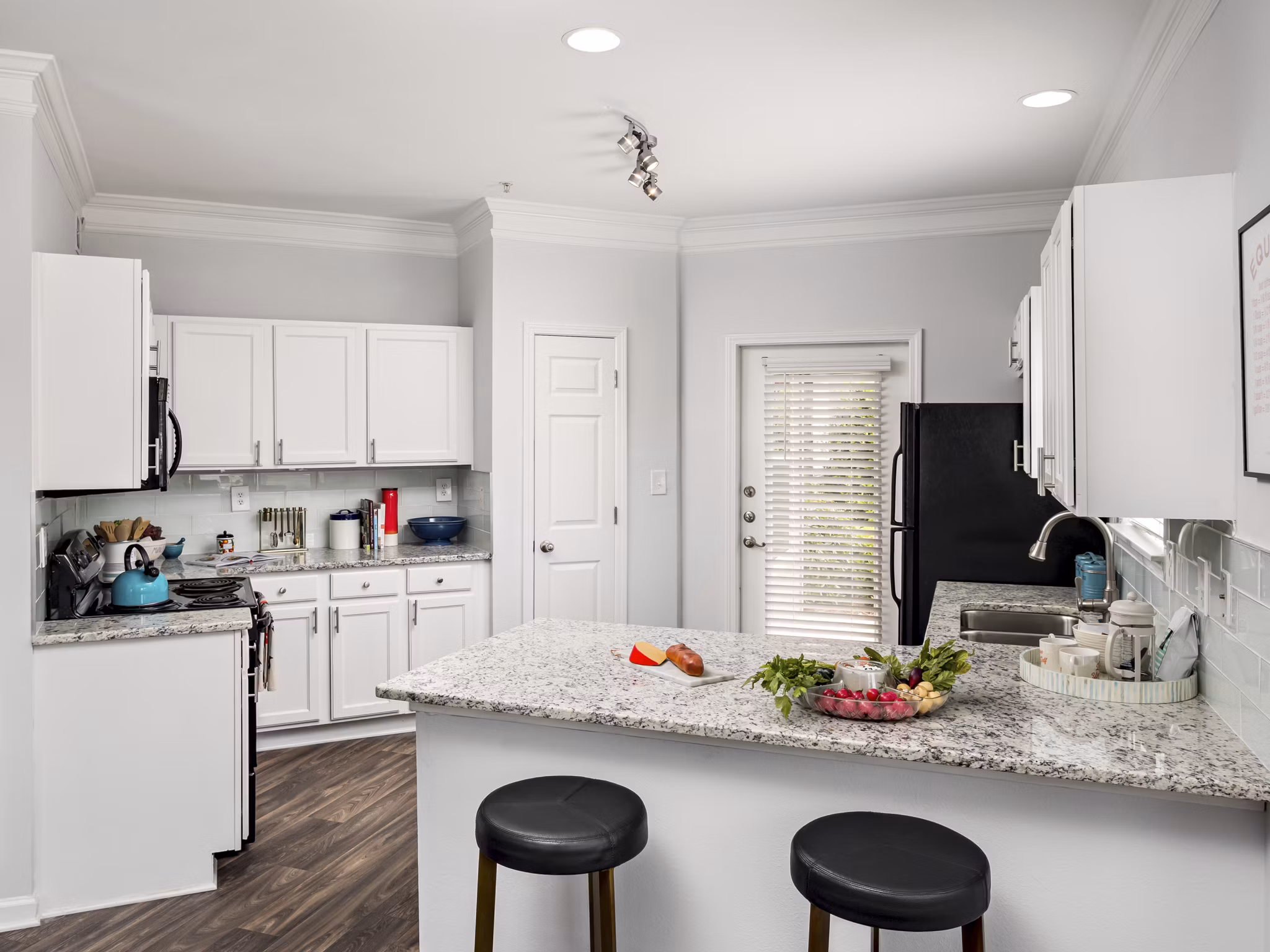Modern kitchen with stainless steel appliances at Mandalay Villas Apartments, luxury living in a serene setting