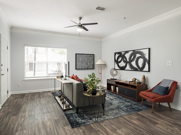 Cozy living room with modern decor at Mandalay Villas Apartments, featuring plush seating and ample natural light