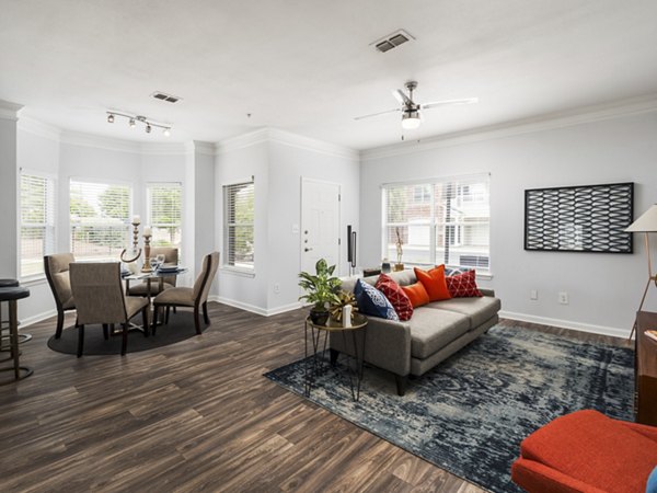Cozy living room with stylish decor and large windows in Mandalay Villas Apartments