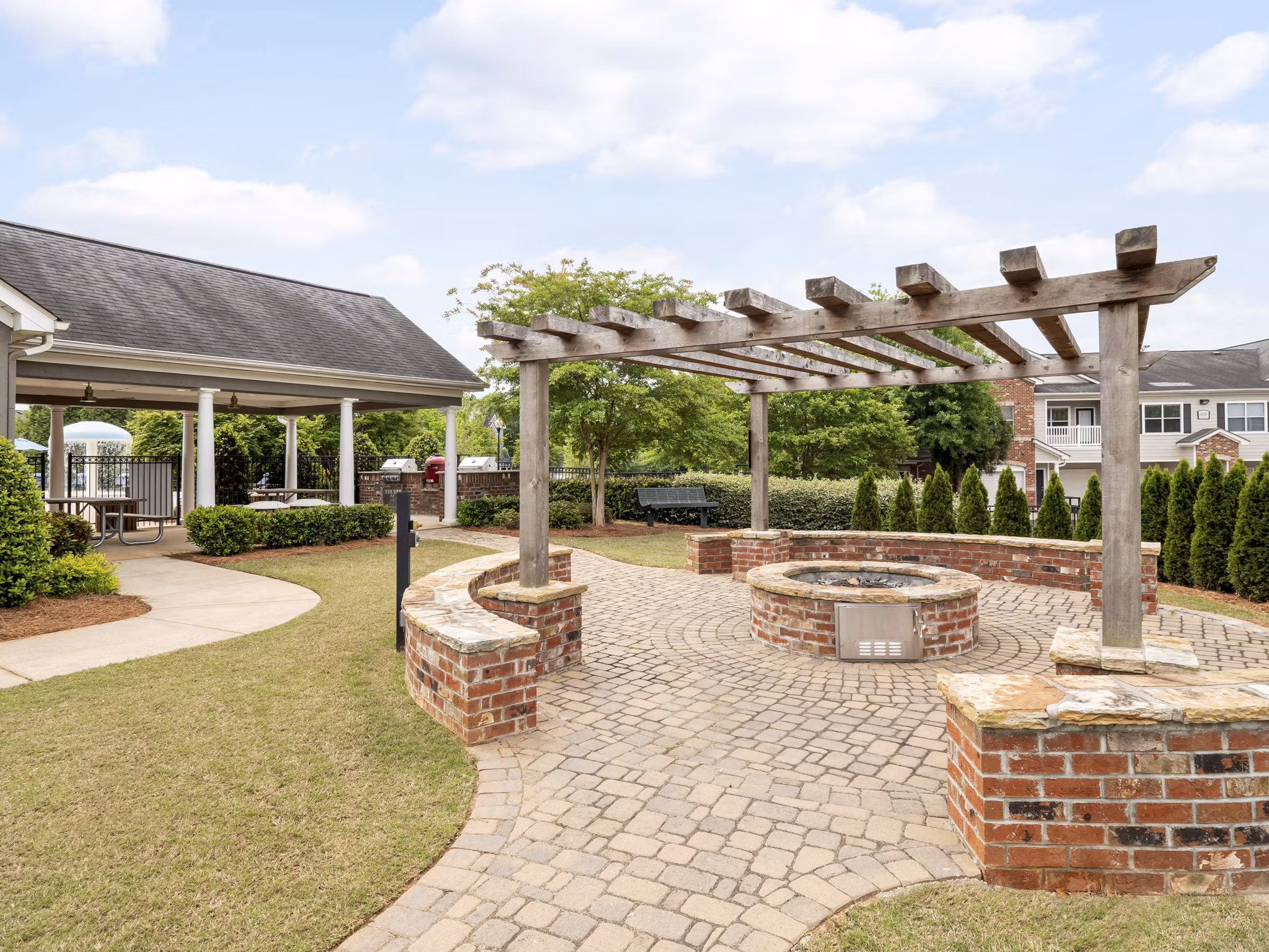 Courtyard with cozy fire pit at Mandalay Villas Apartments, ideal for luxury outdoor relaxation and social gatherings