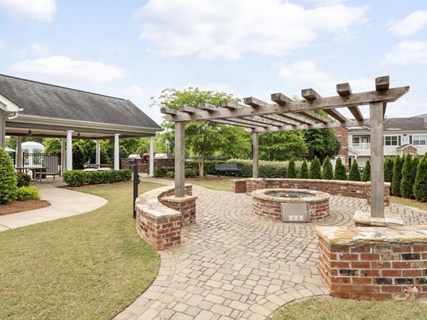 Courtyard with cozy fire pit at Mandalay Villas Apartments, ideal for luxury outdoor relaxation and social gatherings