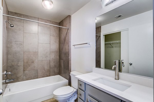 Modern bathroom featuring sleek fixtures and bright lighting in Interurban Building Apartments