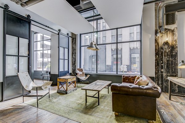 Clubhouse lobby with contemporary decor at Interurban Building Apartments, featuring luxurious seating and stylish lighting for residents