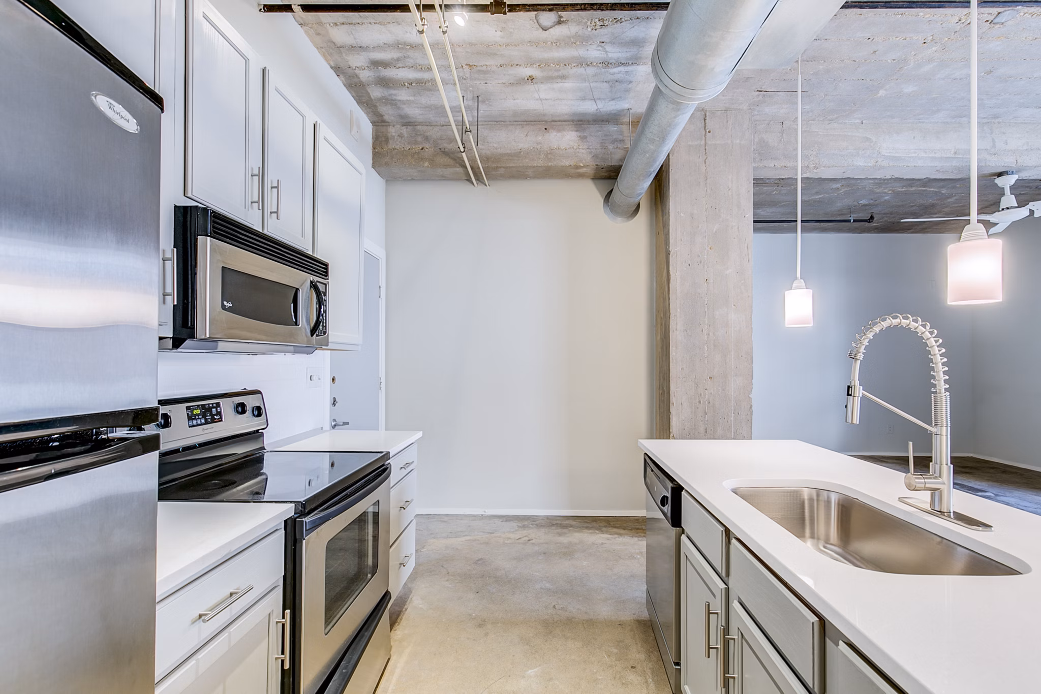 Modern kitchen with stainless steel appliances at Interurban Building Apartments, luxury apartments by Greystar