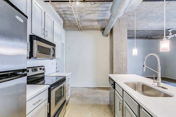 Modern kitchen with stainless steel appliances at Interurban Building Apartments, luxury apartments by Greystar