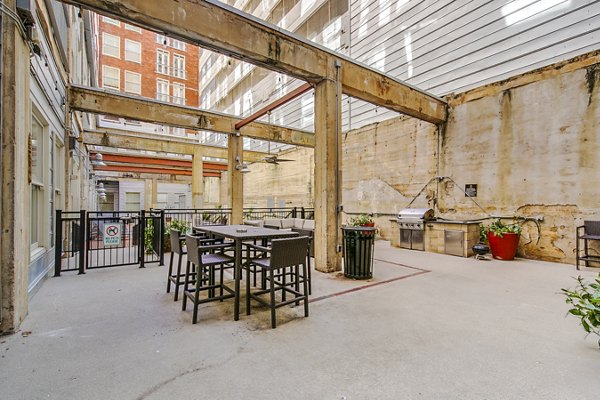 Outdoor patio with modern grill area at Interurban Building Apartments, perfect for luxury urban living