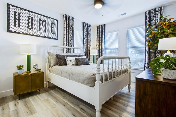 Cozy bedroom with modern furnishings at 1000 West Apartments, Greystar luxury living