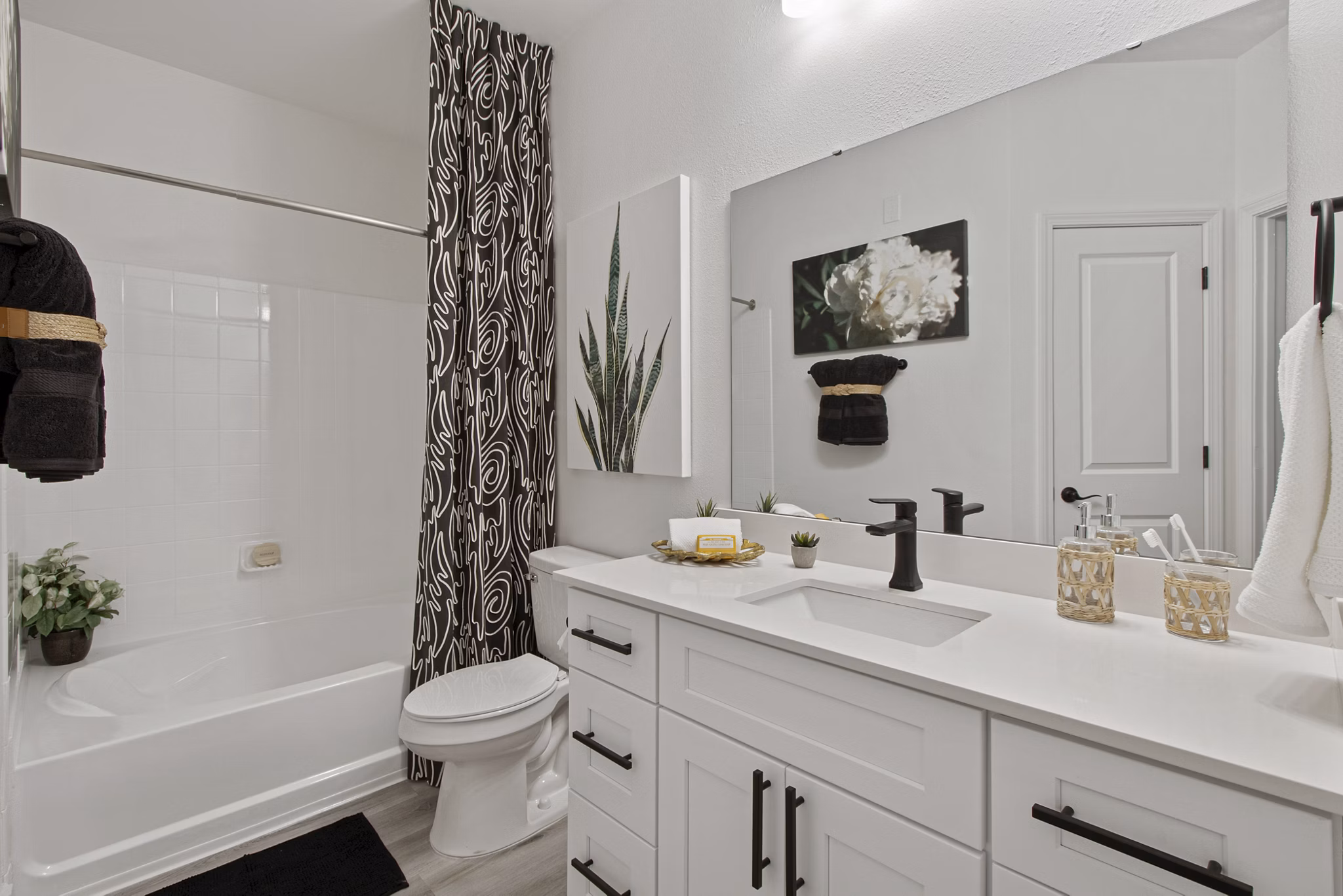 Luxury bathroom featuring marble countertops and modern fixtures at 1000 West Apartments